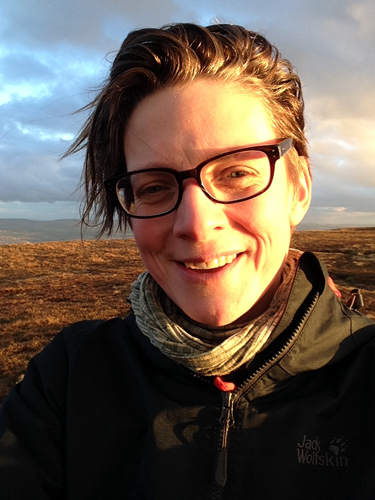 Photograph of a smiling person on a moortop