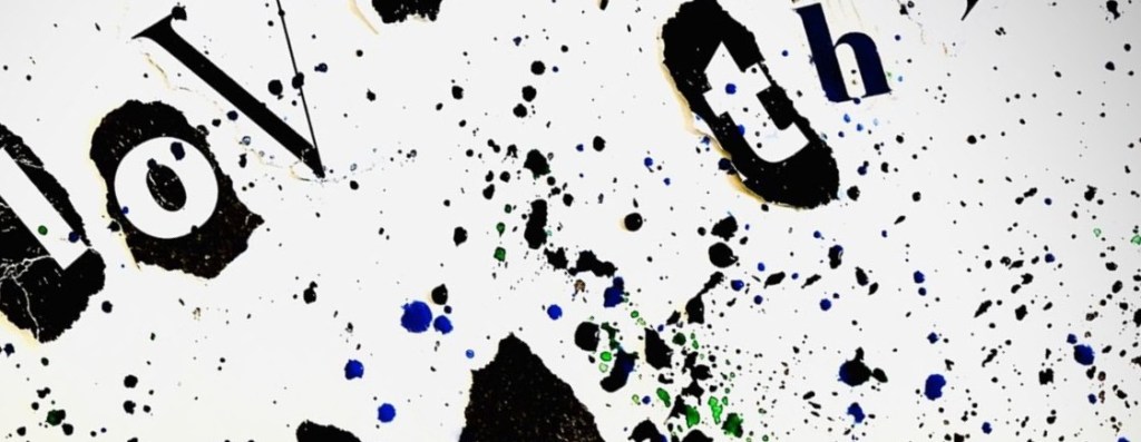 A cut-off paint-splash artwork with uncertain message reading Love and The